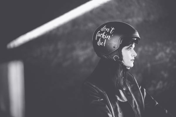 black and white photo of woman with motorcycle helmet